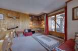 Step into a cozy living space with rustic charm, featuring wood-paneled walls and a welcoming atmosphere.