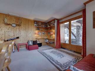 Step into a cozy living space with rustic charm, featuring wood-paneled walls and a welcoming atmosphere.