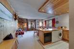This charming property features a cozy living space with wooden accents, creating a warm and inviting atmosphere.