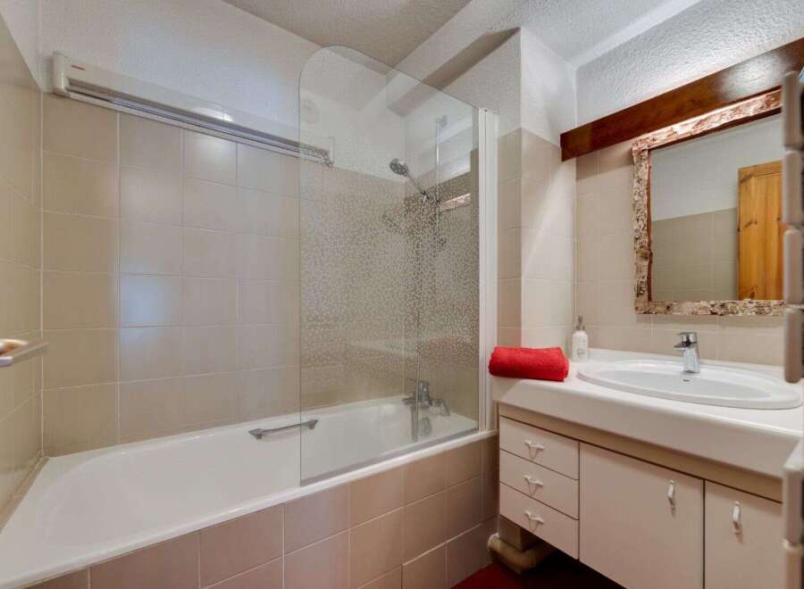 Step into this inviting bathroom featuring a sleek bathtub and a modern glass shower enclosure.