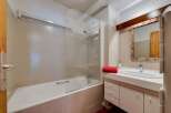 Step into this inviting bathroom featuring a sleek bathtub and a modern glass shower enclosure.