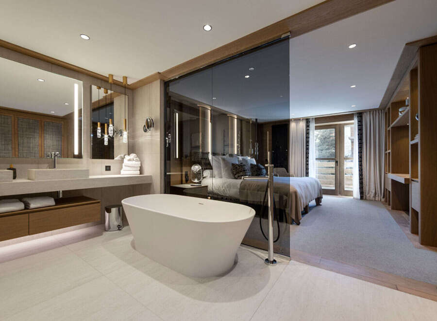 Experience luxury living in this stunning property featuring a modern bathroom with a freestanding tub and a spacious bedroom.