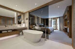 Experience luxury living in this stunning property featuring a modern bathroom with a freestanding tub and a spacious bedroom.