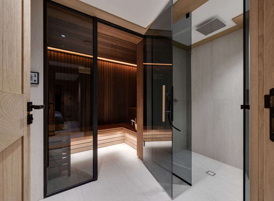 Step into luxury with this stunning spa-like bathroom featuring a modern sauna and a sleek shower.
