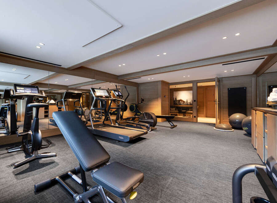 This luxurious home gym offers a comprehensive workout experience with state-of-the-art equipment.