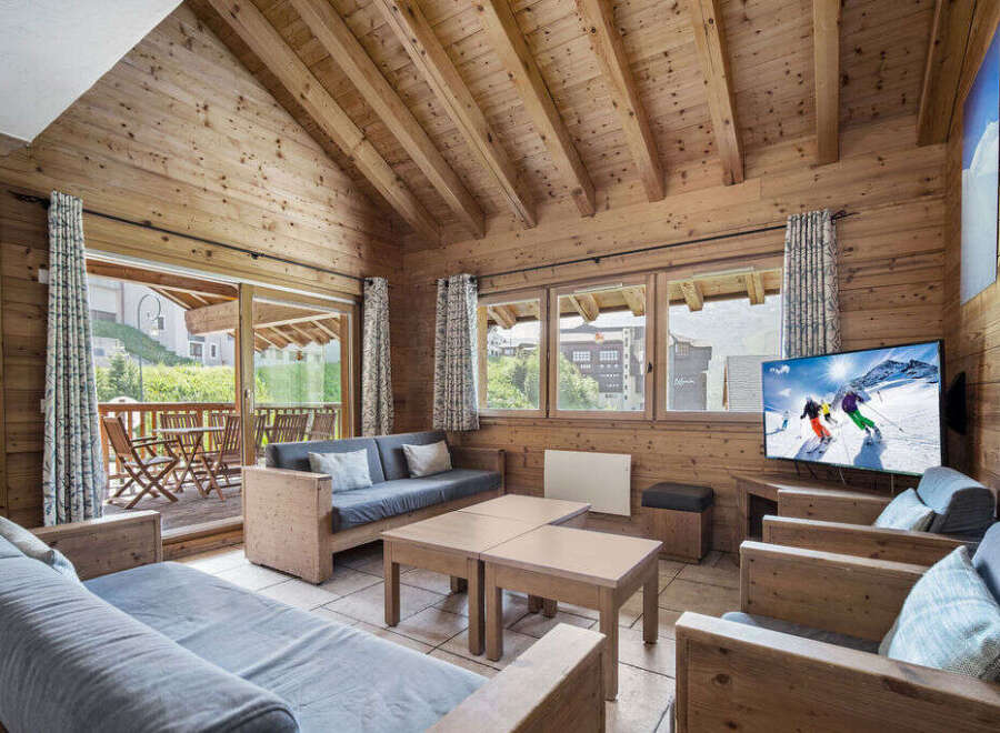 Experience the charm of this cozy chalet, featuring a warm wooden interior and a stunning view.