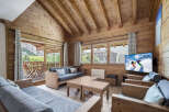 Experience the charm of this cozy chalet, featuring a warm wooden interior and a stunning view.
