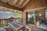 Enjoy breathtaking mountain views from this charming chalet balcony.