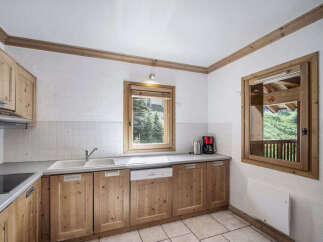 Discover the charm of this inviting kitchen, featuring warm wooden cabinetry and a bright, airy atmosphere.