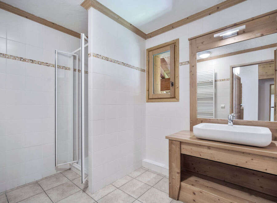 This charming bathroom features a modern design with a touch of rustic elegance.