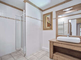 This charming bathroom features a modern design with a touch of rustic elegance.