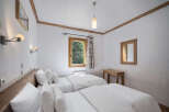 This cozy bedroom features two twin beds with crisp white linens, perfect for a comfortable stay.