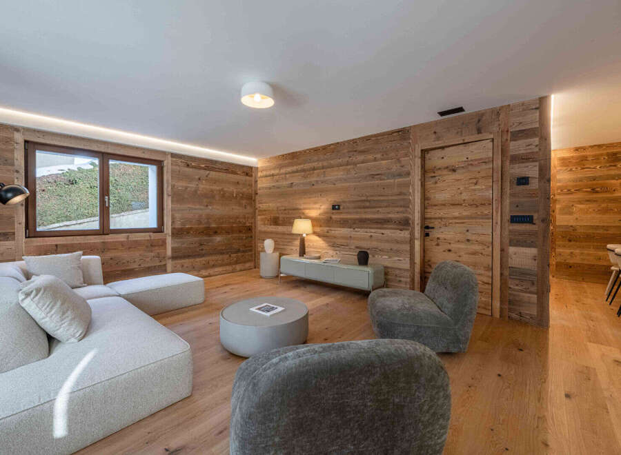 Experience the warmth and charm of this stunning living space, featuring exquisite wood paneling that adds a touch of rustic elegance.