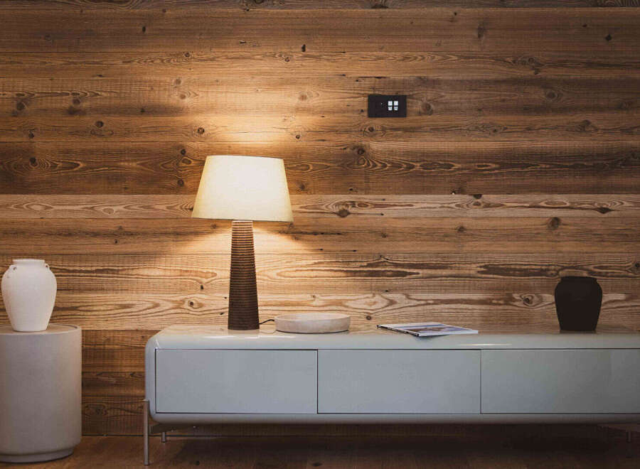 This stunning property features a warm and inviting interior with beautiful wooden paneling.