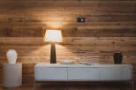 This stunning property features a warm and inviting interior with beautiful wooden paneling.