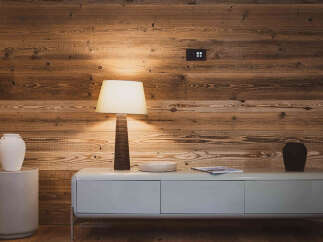 This stunning property features a warm and inviting interior with beautiful wooden paneling.