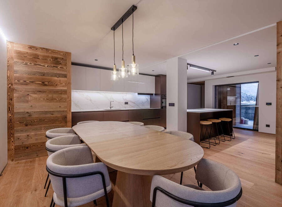 Experience luxury living in this stunning property featuring a modern kitchen with sleek cabinetry and a beautiful marble backsplash.