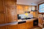 This charming kitchen boasts beautiful wooden cabinetry and a functional layout, perfect for preparing meals.