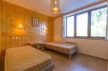 This cozy bedroom features two twin beds, perfect for guests or roommates.