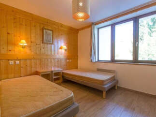 This cozy bedroom features two twin beds, perfect for guests or roommates.