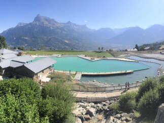 This stunning property boasts a breathtaking view of the mountains and a serene lake.