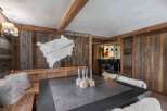Experience rustic elegance in this stunning property, featuring a cozy dining area with a unique wooden aesthetic.
