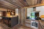 This stunning kitchen showcases rustic charm with its reclaimed wood accents and modern appliances.