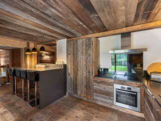 This stunning kitchen showcases rustic charm with its reclaimed wood accents and modern appliances.