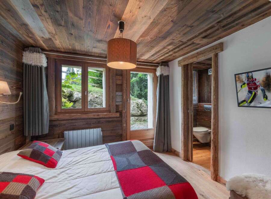 Experience the charm of this cozy bedroom, featuring rustic wooden accents and a warm, inviting atmosphere.