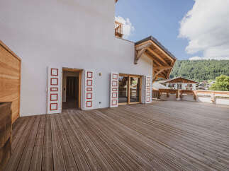 Experience the charm of this stunning property featuring a spacious wooden deck, perfect for outdoor gatherings.