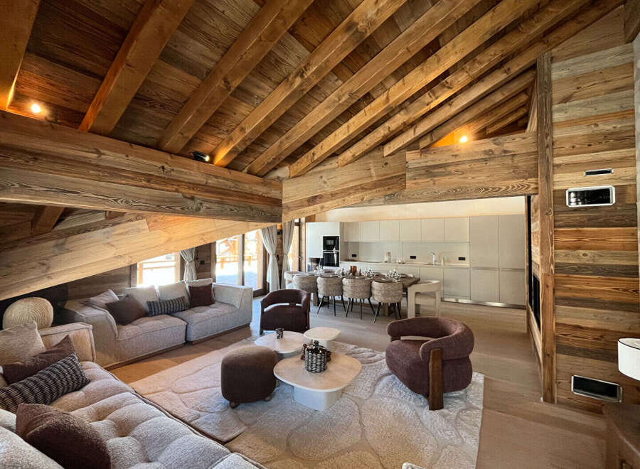 Experience luxury living in this stunning property, featuring a beautifully designed interior with exposed wooden beams and a modern kitchen.