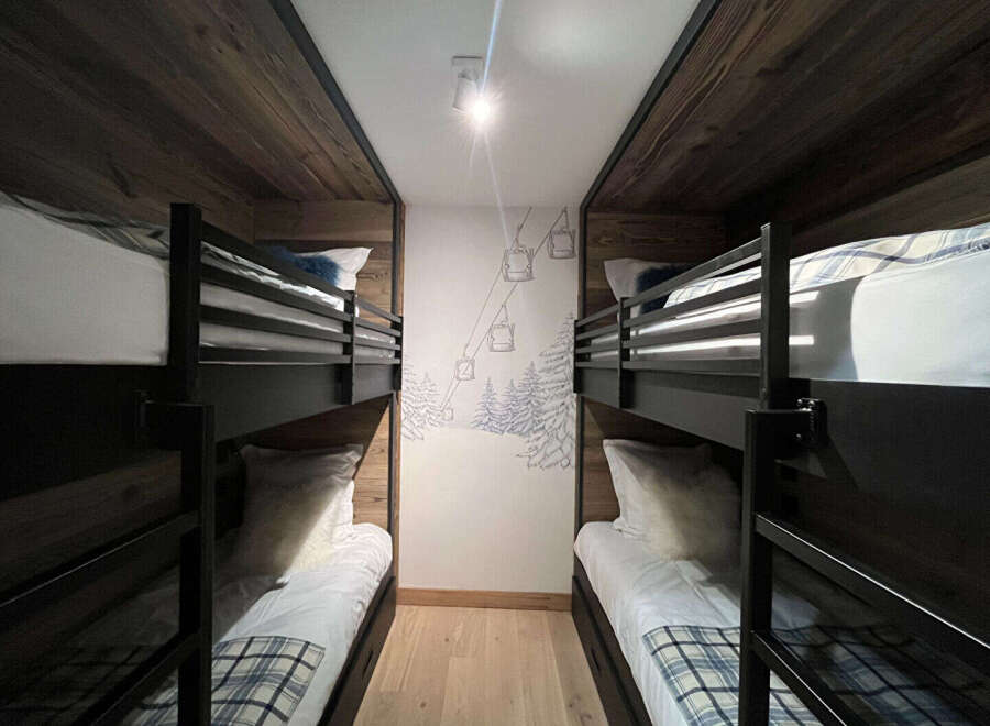 This cozy bunk room offers a unique and inviting space for guests.