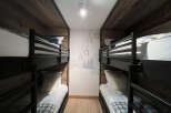This cozy bunk room offers a unique and inviting space for guests.