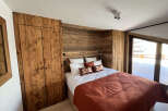 Discover the charm of this cozy bedroom, featuring stunning wooden paneling that adds warmth and character.