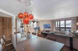 Experience luxury living in this stunning property, featuring a spacious dining area with a modern glass table and stylish pendant lighting.