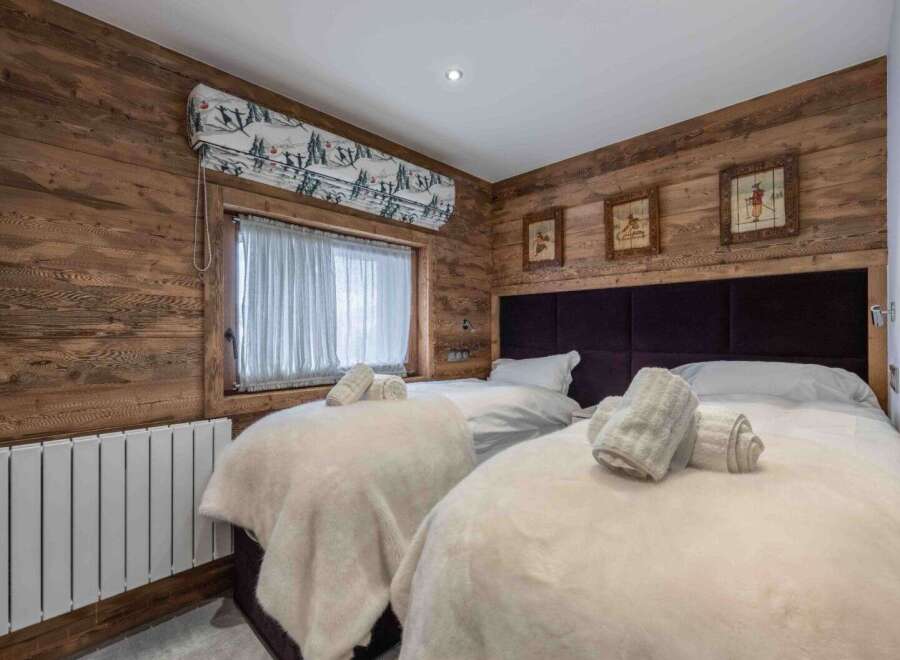 This cozy bedroom features a rustic wooden design, creating a warm and inviting atmosphere.