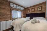 This cozy bedroom features a rustic wooden design, creating a warm and inviting atmosphere.