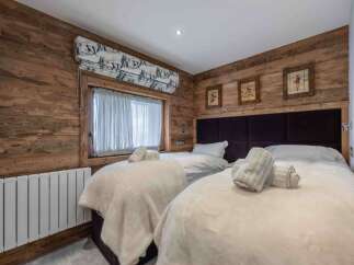 This cozy bedroom features a rustic wooden design, creating a warm and inviting atmosphere.
