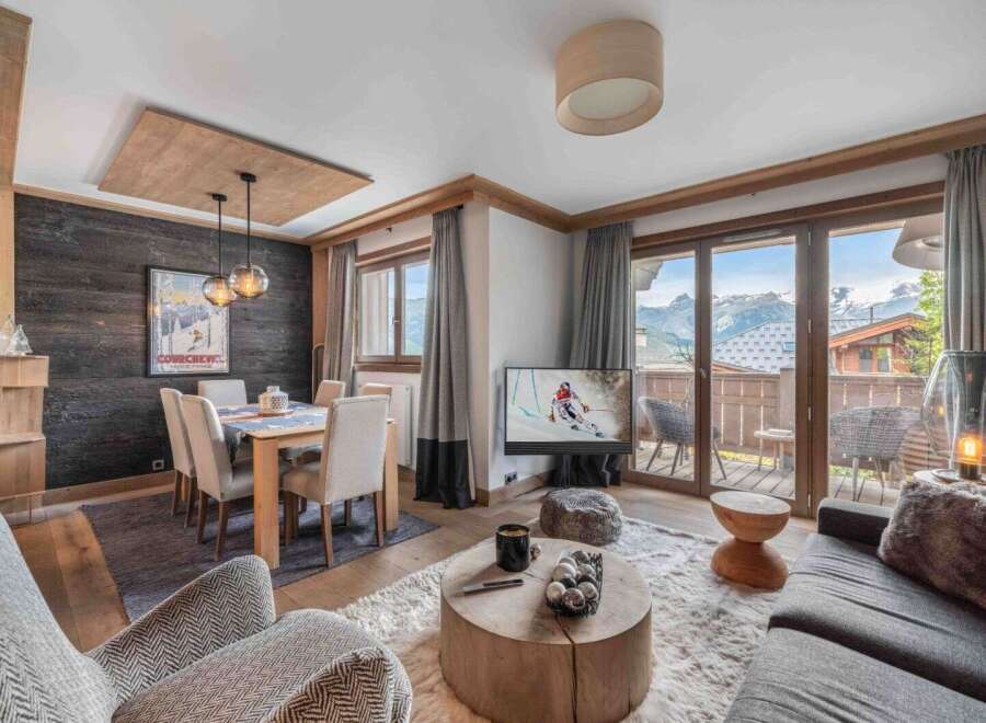 Experience luxury living in this stunning property, featuring a cozy living area with a fireplace and a modern kitchen.