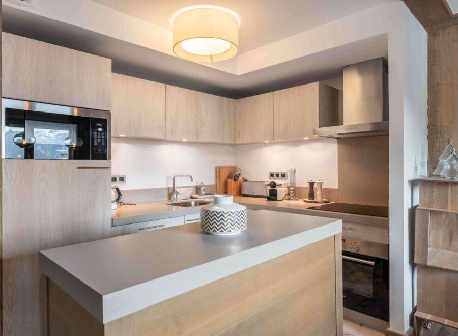 This modern kitchen boasts sleek cabinetry and a stylish island, perfect for culinary enthusiasts.