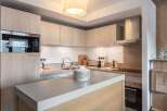 This modern kitchen boasts sleek cabinetry and a stylish island, perfect for culinary enthusiasts.