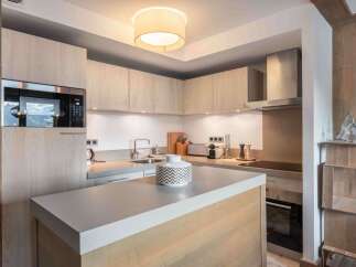 This modern kitchen boasts sleek cabinetry and a stylish island, perfect for culinary enthusiasts.