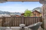 Enjoy breathtaking mountain views from this charming balcony.