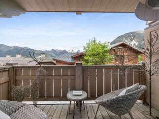 Enjoy breathtaking mountain views from this charming balcony.