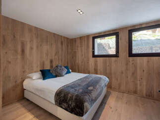This cozy bedroom features stunning wood paneling that adds warmth and character to the space.