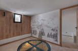 Discover a unique space featuring a stunning mountain-themed mural and a distinctive glass-covered well.