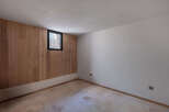 This inviting room features a stunning wood-paneled accent wall, creating a warm and natural ambiance.