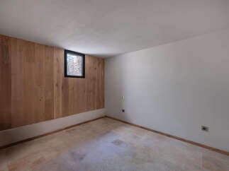 This inviting room features a stunning wood-paneled accent wall, creating a warm and natural ambiance.