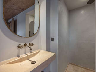 This stunning bathroom boasts a modern design with a unique stone sink and elegant fixtures.
