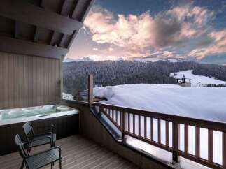 Indulge in luxury with this stunning property featuring a private hot tub overlooking breathtaking mountain views.